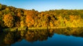 Golden autumn background, aerial view of forest with yellow trees and beautiful lake landscape from above, Kiev, Goloseevo forest Royalty Free Stock Photo