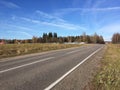 Golden autumn. Empty suburban road with new road markings in sunny autumn day