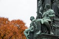 Close up view to part of the bronze Schiller Monument in Vienna with autumn background Royalty Free Stock Photo