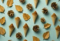 Golden autumn leaves and pine cones pattern flat lay.