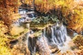 Golden autumn waterfall flowing in tropical rainforest