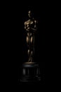 Golden award or trophy. Academy award icon on a black background