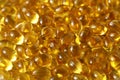 Golden background capsules Close up food supplement oil filled capsules suitable vitamin A, vitamin D3, fish oil, omega 3, 6, 9,