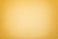 Golden background from a textile material. Fabric with natural texture. Backdrop Royalty Free Stock Photo