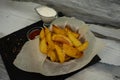 Golden baked new potatoes for dinner. Ketchup sauce and sour cream