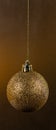 Golden ball Christmas tree toy on a dark Golden background Royalty Free Stock Photo