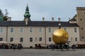 The golden ball statue with a man on the top sculpture, Kapitelplatz Square, Salzburg Royalty Free Stock Photo