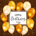 Golden Balloons and Lettering Happy Birthday To You on Wooden Background Royalty Free Stock Photo