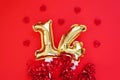 Golden 14 balloons souvenir heart isolated on red background. Helium balloons gold foil numbers.