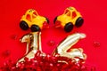 Golden 14 balloons souvenir heart and a toy taxi isolated on red. Helium balloons gold foil numbers. Numbers for