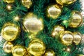 Golden balls and baubles hanging as decorations on a Christmas tree, close-up Royalty Free Stock Photo