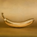 Golden banana on gold background