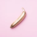 Golden banana on pink background. Creative food concept. Top view. Flat lay. Single exotic gold fruit