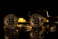 Gold ingot and bitcoin against black background