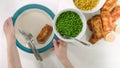 Golden batter deep fried fish fillet, served with green peas, sweet corn, and slices of lemon close up Royalty Free Stock Photo