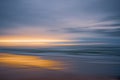 Golden beach sunset. Beautiful abstract seascape. Soft golden light, blue sea, and cloudy sky Royalty Free Stock Photo