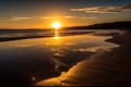 golden beach sunset, with the sun setting over the ocean, reflecting in the water Royalty Free Stock Photo