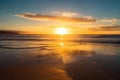 golden beach sunset, with the sun setting over the ocean, reflecting in the water Royalty Free Stock Photo