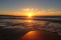 golden beach at sunset, with a view of the evening sky and the setting sun Royalty Free Stock Photo