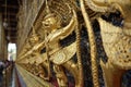 The golden beautiful ornamental of Thailand art & craft of Garuda holding the Naga at The Temple of the Emerald Buddha