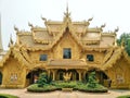 Golden beautiful paint building decorated with Thai stucco pattern is toilet of Rong Khun temple Wat Rong Khun.
