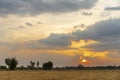 Golden beautiful Sunset clear at dry grass fields and bamboo tree in the countryside at evening Royalty Free Stock Photo