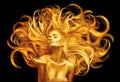 Golden beauty woman. Sexy model girl with golden makeup and long hair pointing hand over black. Metallic gold glowing skin