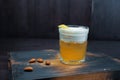 Golden beer with white foam in a beer glass is standing on a black wooden table in the bar. The drink is decorated with peanuts Royalty Free Stock Photo