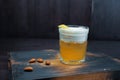 Golden beer with white foam in a beer glass is standing on a black wooden table in the bar. The drink is decorated with peanuts. Royalty Free Stock Photo
