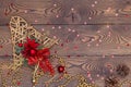 Golden bell from rattan with pine cones, Christmas toys, shiny beads and small red shiny stars on a wooden table. Top view, copy Royalty Free Stock Photo