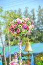 A golden bell under artificial flowers