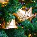 Golden bells hanging as decorations on a Christmas tree, close-up Royalty Free Stock Photo