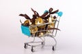 Golden bells with a ribbon bow, in the shopping basket.