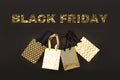 Golden benner BLACK FRIDAY with shopping bag, gift box in modern style on black background. Sale in modern design. Minimal concept Royalty Free Stock Photo