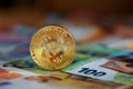 Golden bitcoin BTC on euro banknotes Royalty Free Stock Photo