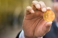 Golden bitcoin in businessman hand, YoungÃ¢â¬â¢s fingers catch bitcoin in the air,bokeh,morning light purple background,content to