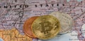 Golden Bitcoin Coin close up together with silver bitcoin and bronze bitcoin with blurred background of United States Royalty Free Stock Photo