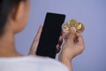 Golden bitcoin coin Dogecoin DOGE, Ethereum ETH group included with Cryptocurrency on hand woman or girl and mobile phone Royalty Free Stock Photo