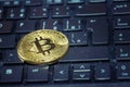 Golden bitcoin coin on computer keyboard, cryptocurrency bitcoin mining concept Royalty Free Stock Photo