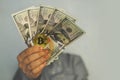 Golden Bitcoin coin on man's hand on blurred background,