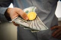 Golden Bitcoin coin on man's hand on blurred background,