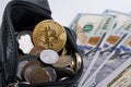 Golden bitcoin coin  over money coins  in wallet around dollars. close up Royalty Free Stock Photo