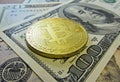 Golden bitcoin coin on us dollars close up Royalty Free Stock Photo