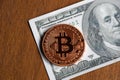 Golden bitcoin coin on us dollars close up Royalty Free Stock Photo