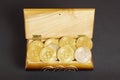 Golden bitcoin coins in the treasure trove, cryptocurrency in wooden chest, gift, decoration on black paper background