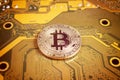 Golden bitcoin on computer circuit board, close-up Royalty Free Stock Photo