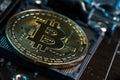Golden Bitcoin Cryptocurrency on computer circuit board CPU. Macro shot Royalty Free Stock Photo