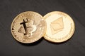 Golden Bitcoin and Ethereum on black wooden table