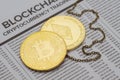 Golden Bitcoin and Ethereum coins with chain on mockup newspaper page