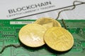 Golden Bitcoin and Ethereum coins with chain on printed circuit board